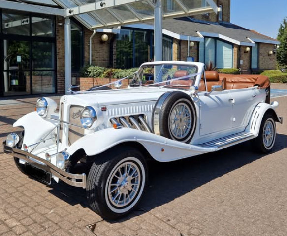 White Beauford tourer with tan leather interior, dressed with white ribbons